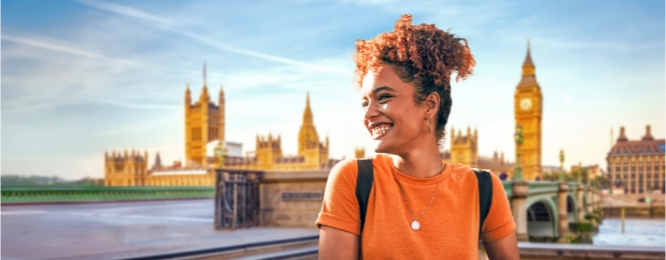 Women smiling with buildings behind her